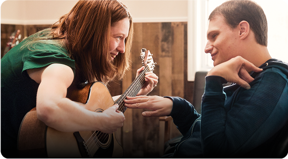 Patient with LGS Using EPIDIOLEX | Woman playing guitar for a smiling man