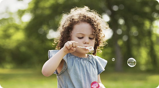TSC Associated Seizure Treatment | Young girl happily blowing bubbles